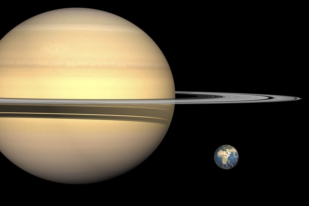 Illustration of Saturn and Earth to scale Canvas Art - Walter MyersStocktrek Images (18 x 12)