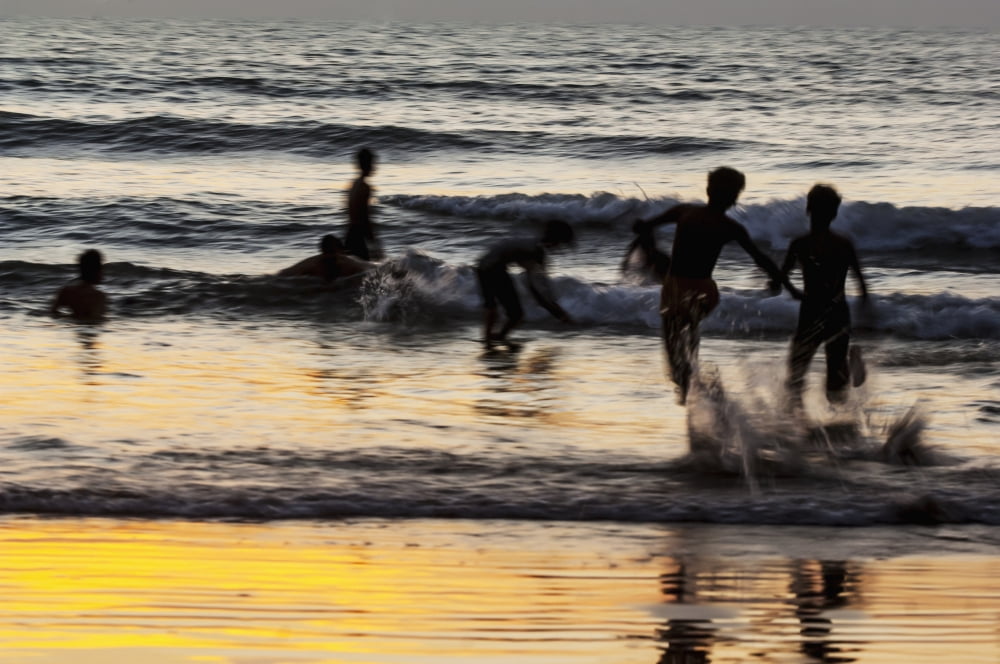 India Karnataka Blurry Figures In Crashing Waves At Gokarna Beach Gokarna Canvas Art - James Sparshatt Design Pics (19 x 12)