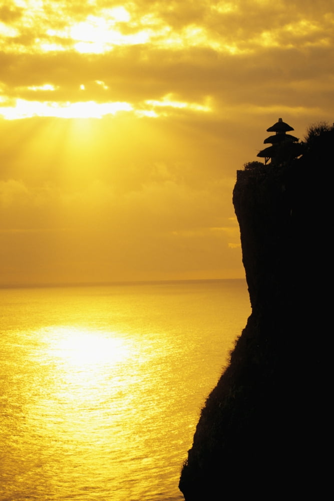 Indonesia Bali Uluwatu Temple Silhouetted In Distance Along Cliff Golden Sunset Reflections On Ocean Canvas Art - Dana Edmunds Design Pics (22 x 34)
