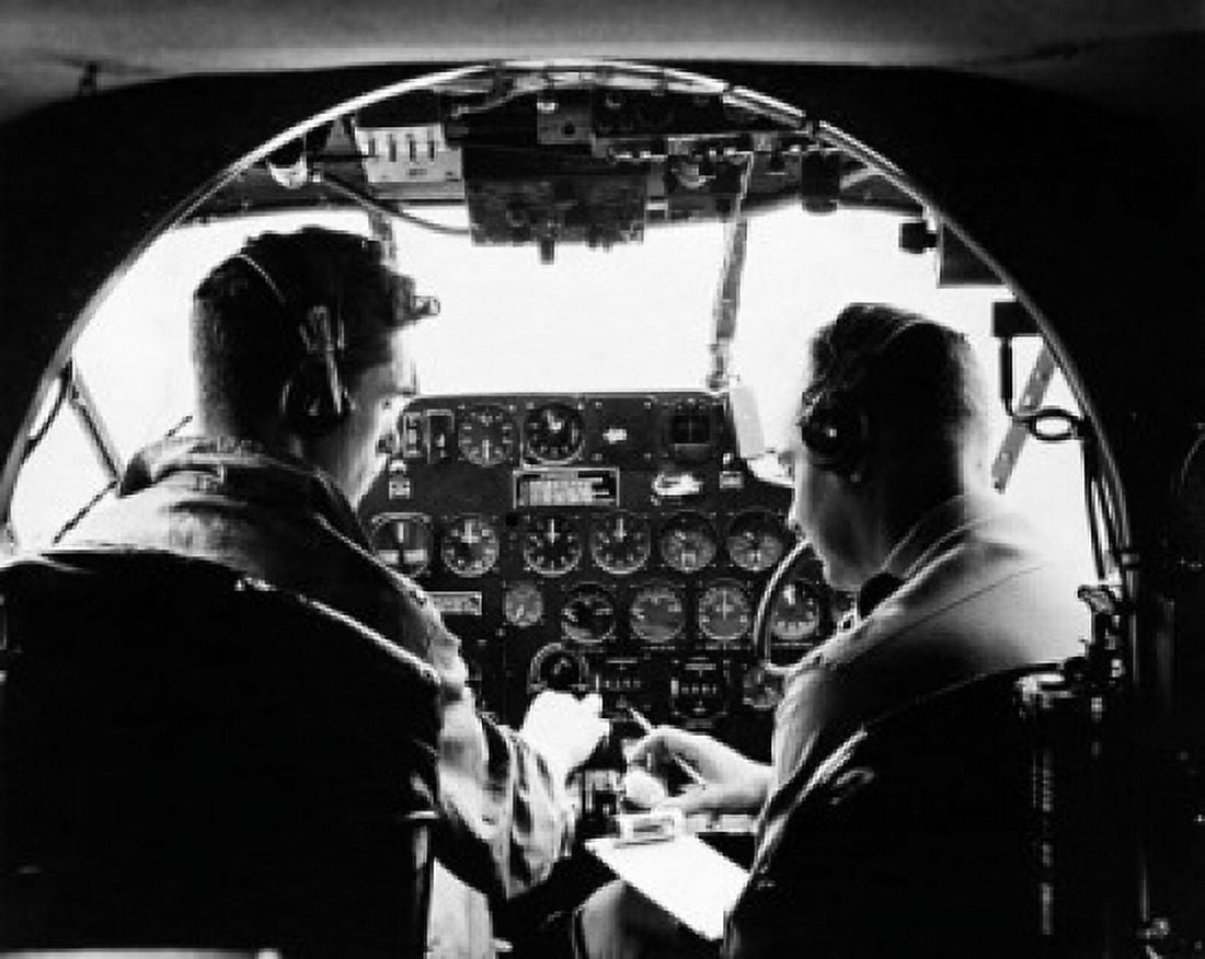 Instructor giving pre-flight instruction to a student in a C-45 airplane Canvas Art - (24 x 36)
