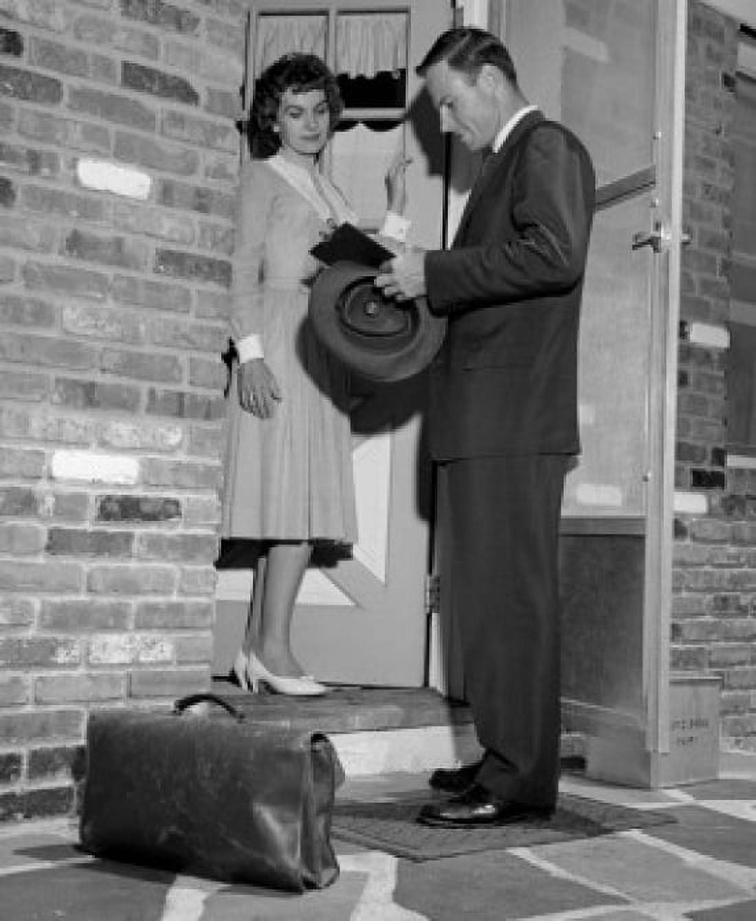 Insurance agent talking to young housewife at front door Canvas Art -  (18 x 24)