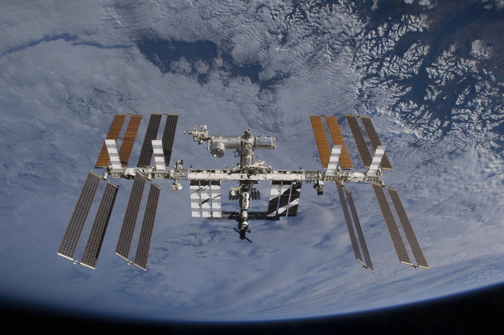 International Space Station set against the background of a cloud covered Earth Canvas Art - Stocktrek Images (34 x 23)