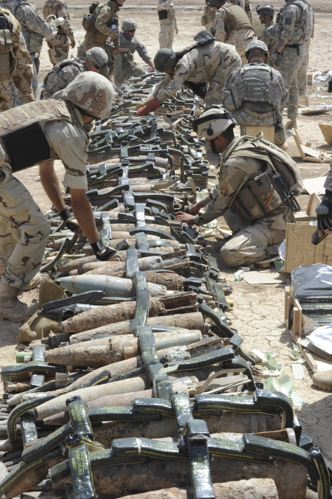 Iraqi soldiers and the US Army place C4 plastic explosives on unexploded ordnance Canvas Art - Stocktrek Images (23 x 34)