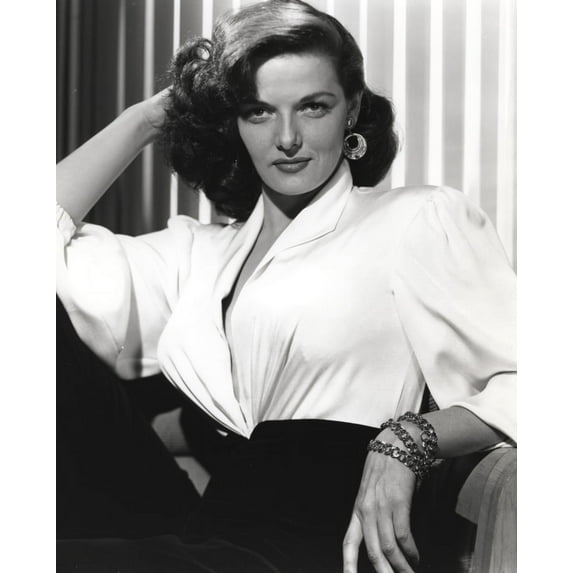 Jane Russell Posed in White Linen V-Neck Dress and Black Linen High Waist Pants with Layered Hoop Earrings while Right Hand Placed Behind the Head Photo Print (8 x 10)