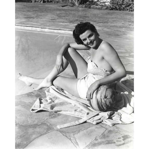 Jane Russell Posed sitting on the Pool in White One Piece Swimsuit with Right Knee Bent while the Left Hand Touching a Ball Photo Print (24 x 30)