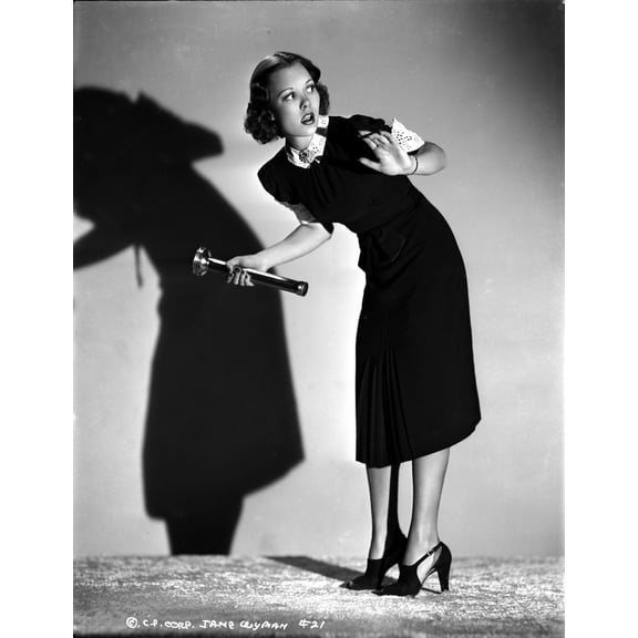 Jane Wyman Posed in Black Velvet Short Sleeve Dress with White Ruffle Collar and Sleeves with Right Hand Holding a Flash Light Photo Print (8 x 10)