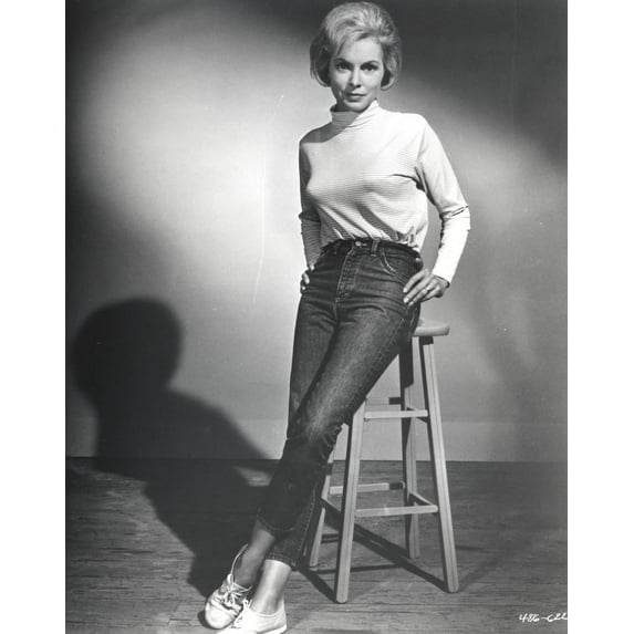 Janet Leigh sitting on the Chair in White High Neck Long Sleeve Linen Shirt and Black High Waist Tight Pants with Legs Crossed and Hands on the Waist Photo Print (24 x 30)