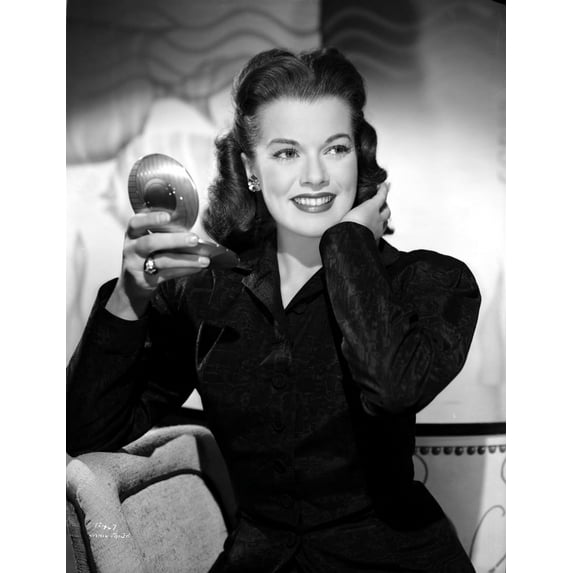 Janis Paige sitting on a Couch in Black Long Sleeve Shirt with Right Hand Holding a Mirror Photo Print (8 x 10)