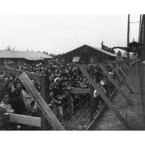 Japanese Americans Behind Barbed Wire Fence Waving To Friends Leaving Santa Anita Camp On A Train. From 1942 To 1944