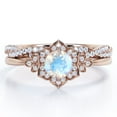 thumbnail image 1 of JeenMata Flower Halo Bezel 1.75 Carat Round Cut Blue Moonstone and Moissanite Infinity Twisted Band Wedding Ring Set in 18K Rose Gold Plating over Silver, 1 of 6
