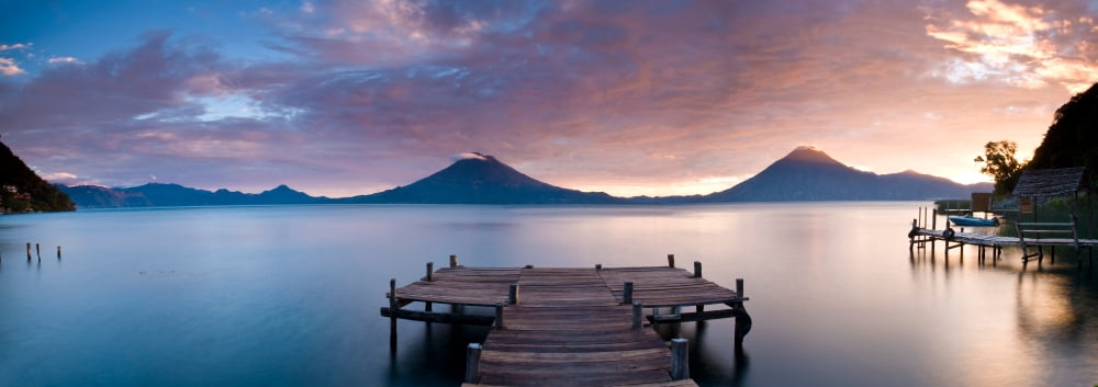 Jetty in a lake with a mountain range in the background Lake Atitlan Santa Cruz La Laguna Western Highlands Guatemala Canvas Art - Panoramic Images (27 x 9)