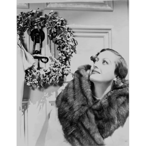 Joan Crawford wearing a fur scarf beside a wreath Photo Print (8 x 10)
