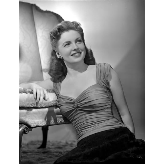 Joan Leslie on a Ruffled Top sitting on a Floor and smiling Photo Print (24 x 30)