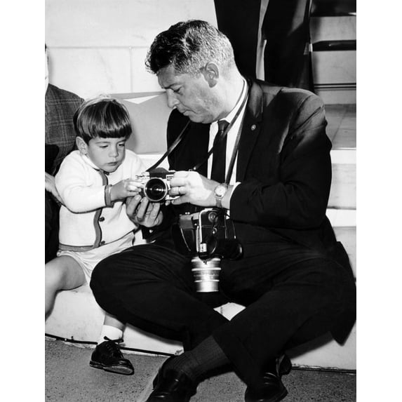 John F. Kennedy Jr. Takes An Interest In The Cameras Of White House Photographer Capt. Cecil Stoughton. Nov. 11 History