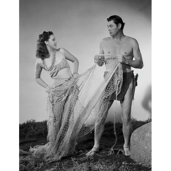 Johnny Weissmuller Holding a Fish Net with a Woman in a Classic Movie Scene Photo Print (8 x 10)