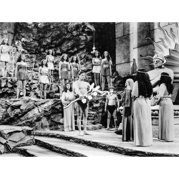 Johnny Weissmuller Presenting His Gifts in a Classic Movie Scene Photo Print (24 x 30)