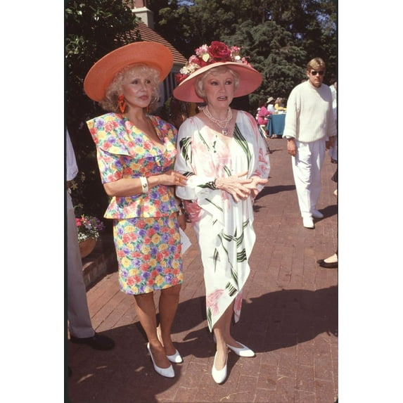 Josette Banzet In Floral Skirt Suit And Orange Hat With Phyllis Diller In White Dress With Pink Flowers And Pink Hat With Large Flowers Photo Print (16 x 20) - Item # CPA3421
