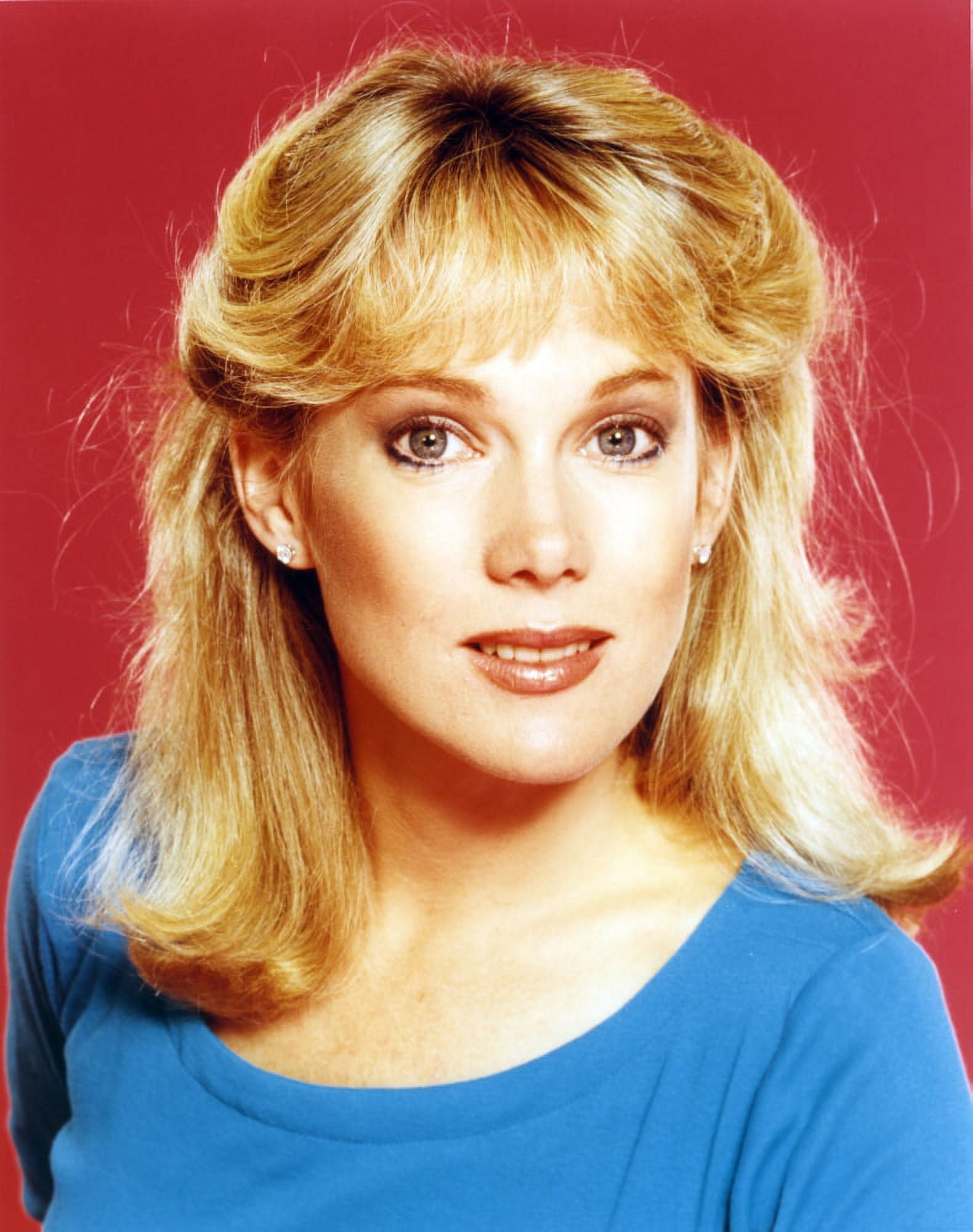 Julia Duffy wearing a Blue Tunic and Earrings in a Close Up Portrait