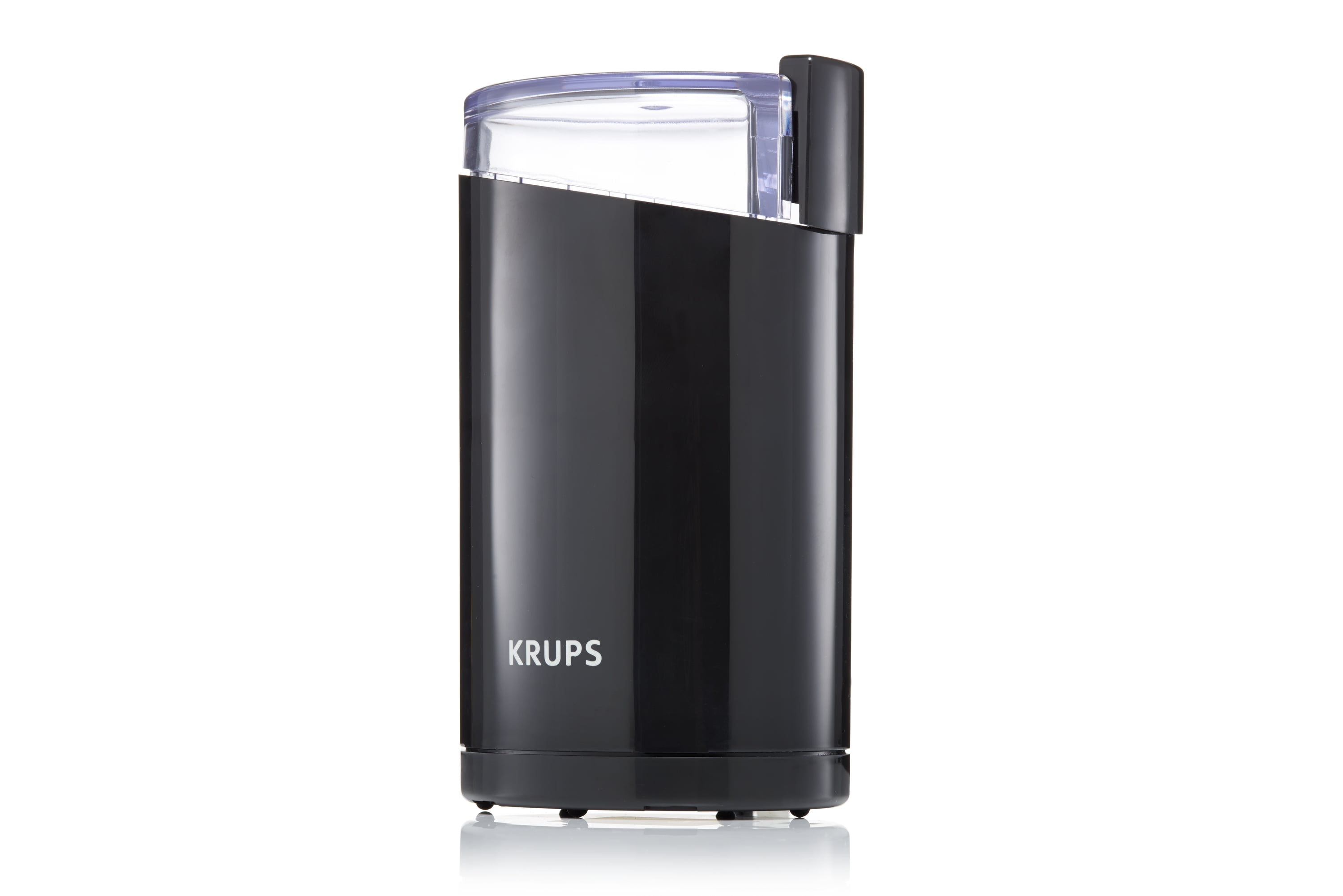 black coffee grinder with coffee beans in it and ground coffee in front