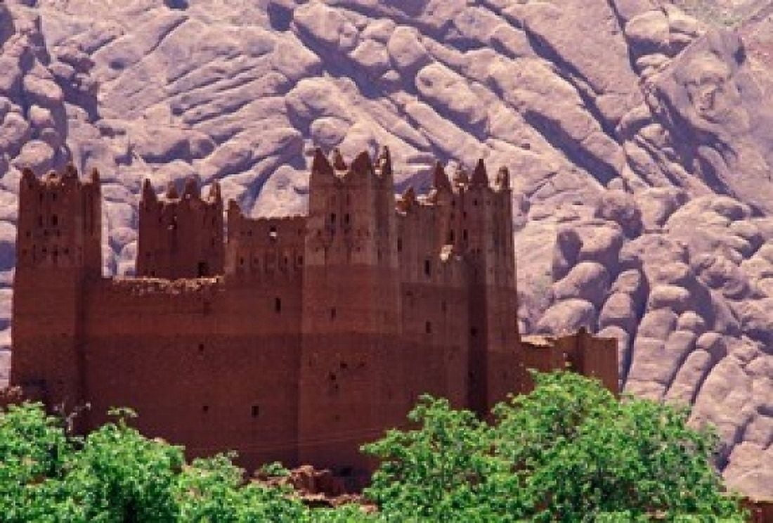 Kasbah and Unique Rock Formation Morocco Canvas Art - John & Lisa Merrill DanitaDelimont (24 x 15)