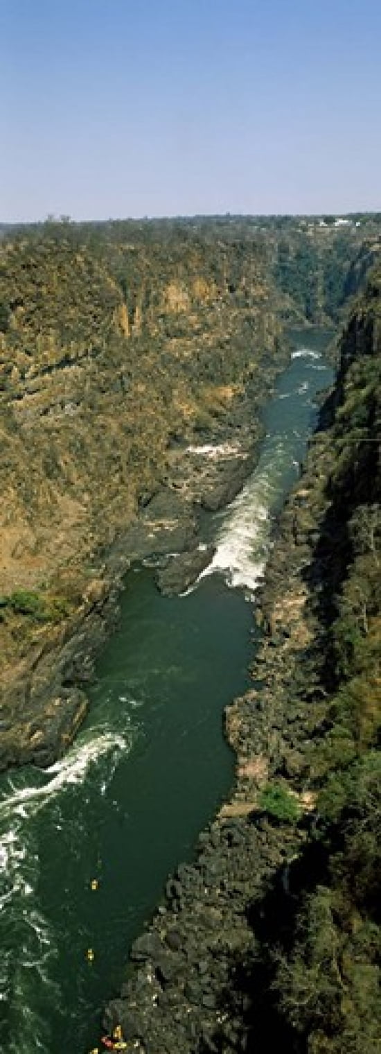 Kayakers paddle down the Zambezi gorge away from the Victoria Falls Zambia Canvas Art - Panoramic Images (36 x 13)