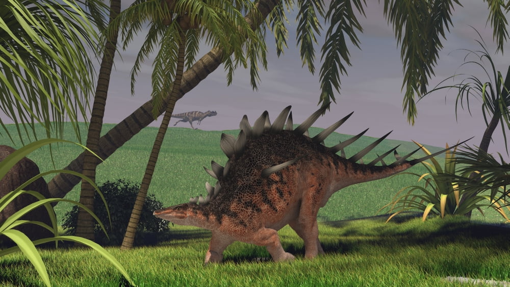 Kentrosaurus walking through a field with a Ceratosaurus in background Canvas Art - Kostyantyn IvanyshenStocktrek Images (19 x 11)