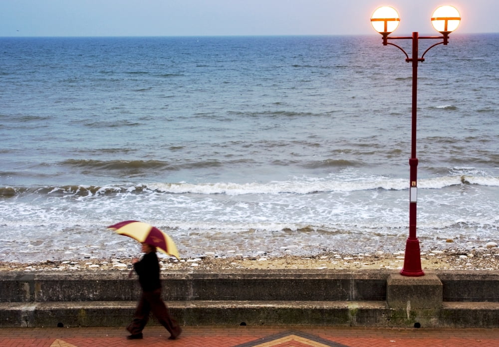 Lady With An Umbrella Walking Along Bridlington Prom Yorkshire England Canvas Art - John Short Design Pics (36 x 24)