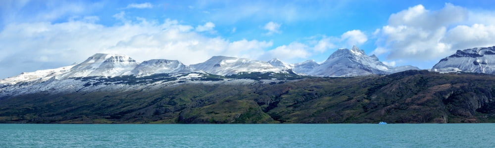 Lake with snow capped mountains in background Lago Argentino Santa Cruz Province Patagonia Argentina Canvas Art - Panoramic Images (12 x 38)