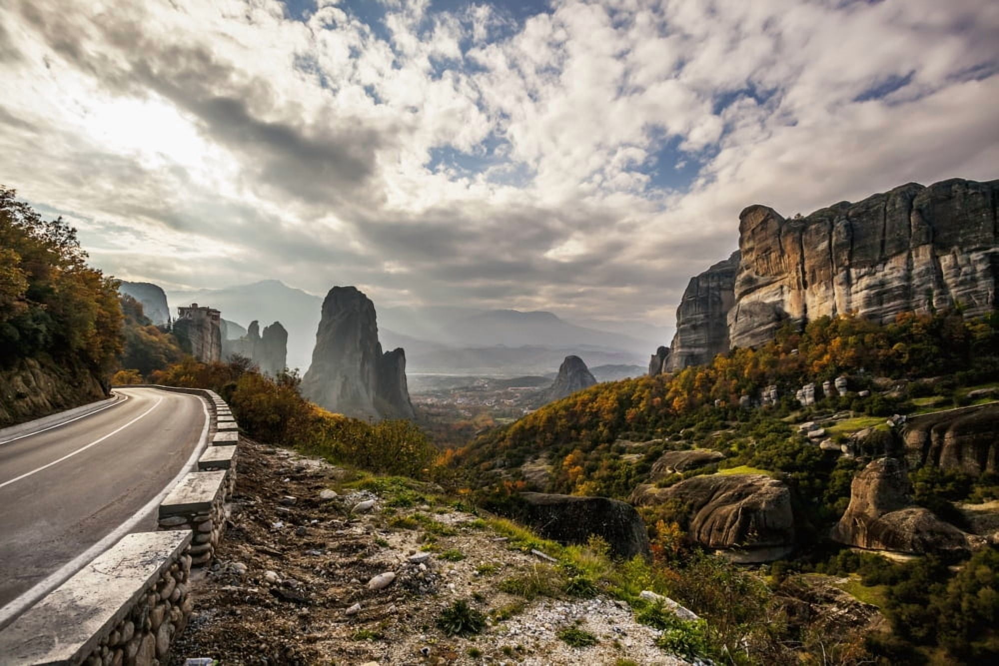 Landscape of rugged cliffs road autumn foliage and Monastery Rousanou in the distance Meteora Greece Canvas Art - Reynold Mainse Design Pics (38 x 24)