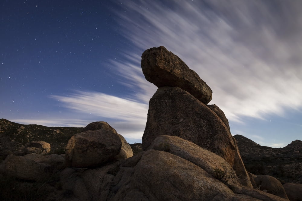 Large boulders backdropped by stars and clouds California Canvas Art - Dan BarrStocktrek Images (18 x 12)