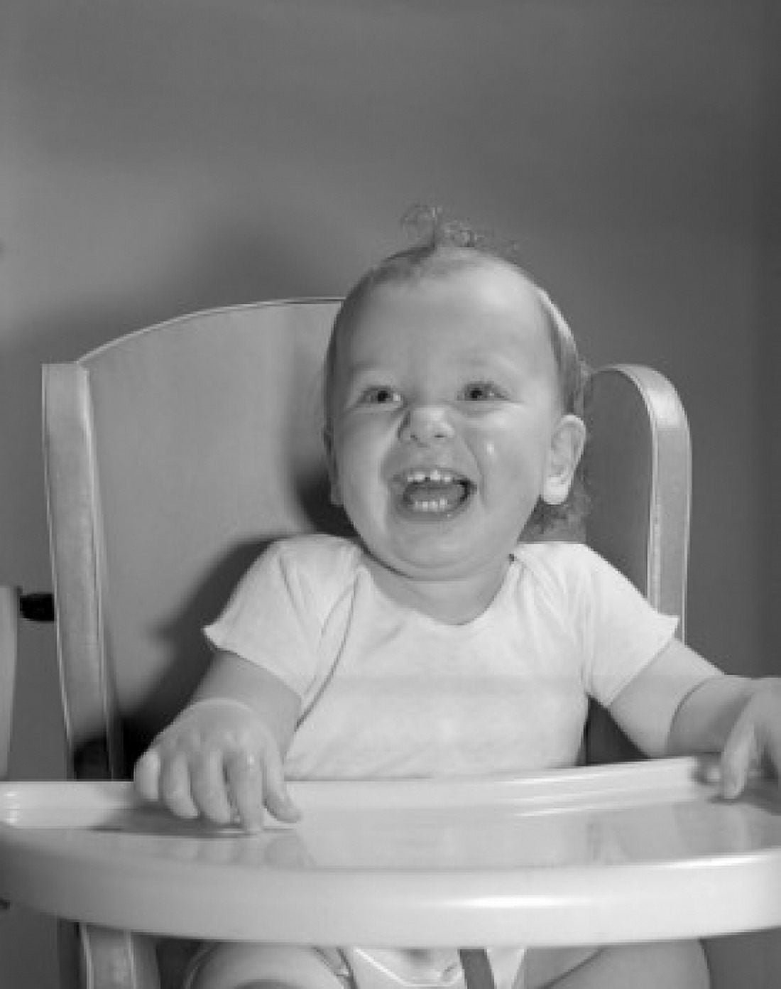 Laughing baby sitting in high chair Canvas Art - (18 x 24)