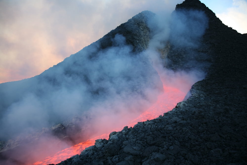 Lava flowing from base of hornito during eruption of Mount Etna volcano Sicily Italy Canvas Art - Richard RoscoeStocktrek Images (35 x 23)