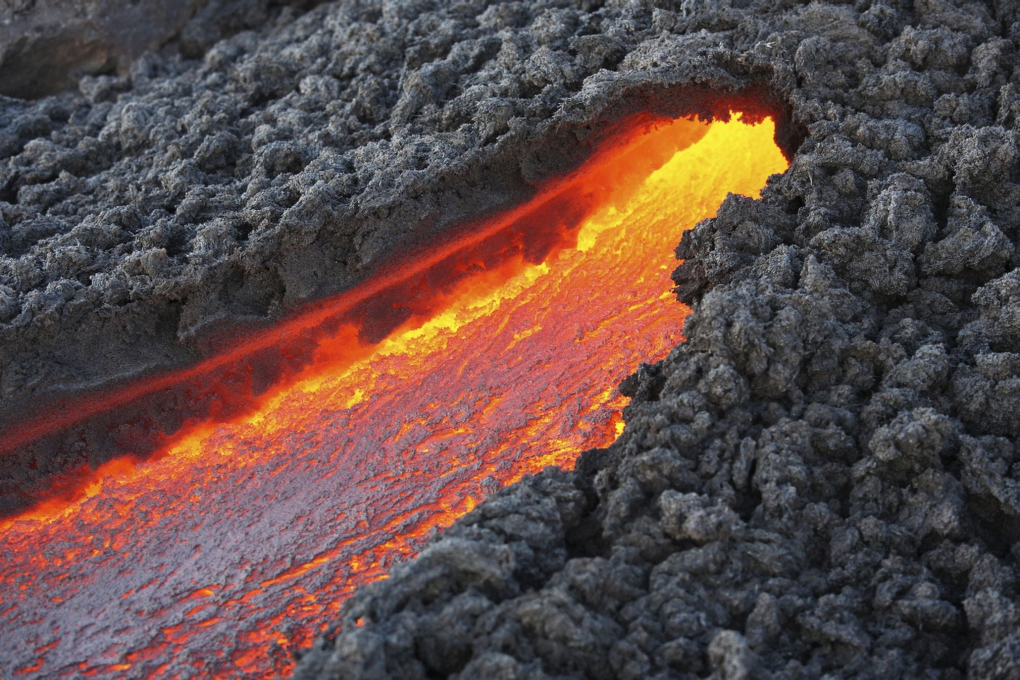 Lava flowing from small tunnel on flank of Pacaya volcano Guatemala Canvas Art - Richard RoscoeStocktrek Images (35 x 23)