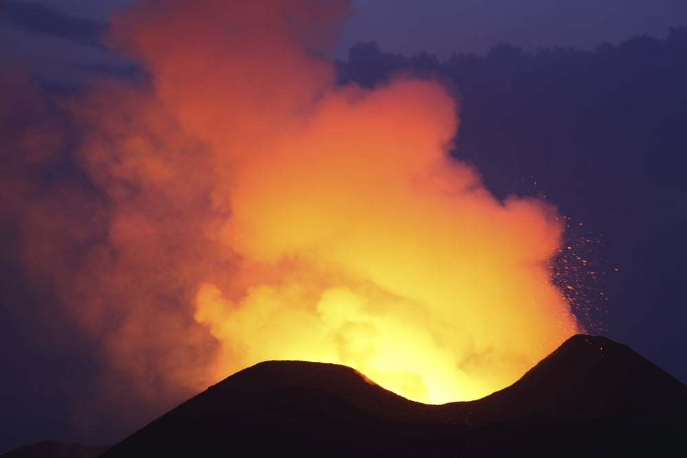 Lava in crater glowing during blue hour on Nyamuragira Volcano Canvas Art - Richard RoscoeStocktrek Images (35 x 23)