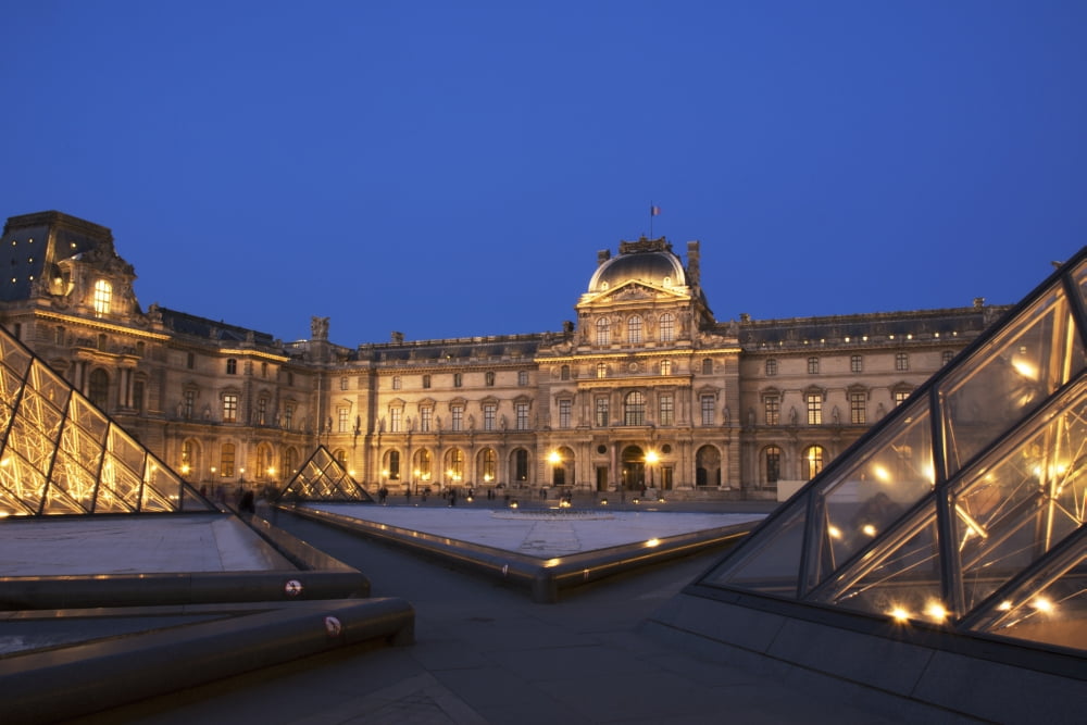Le Louvre palace buildings and pyramids at night in golden light Paris France Canvas Art - Philippe Widling Design Pics (19 x 12)