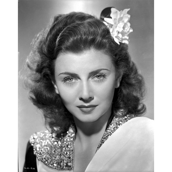 Lenore Aubert on a Beaded Collar With Flower on Head Photo Print (8 x 10)