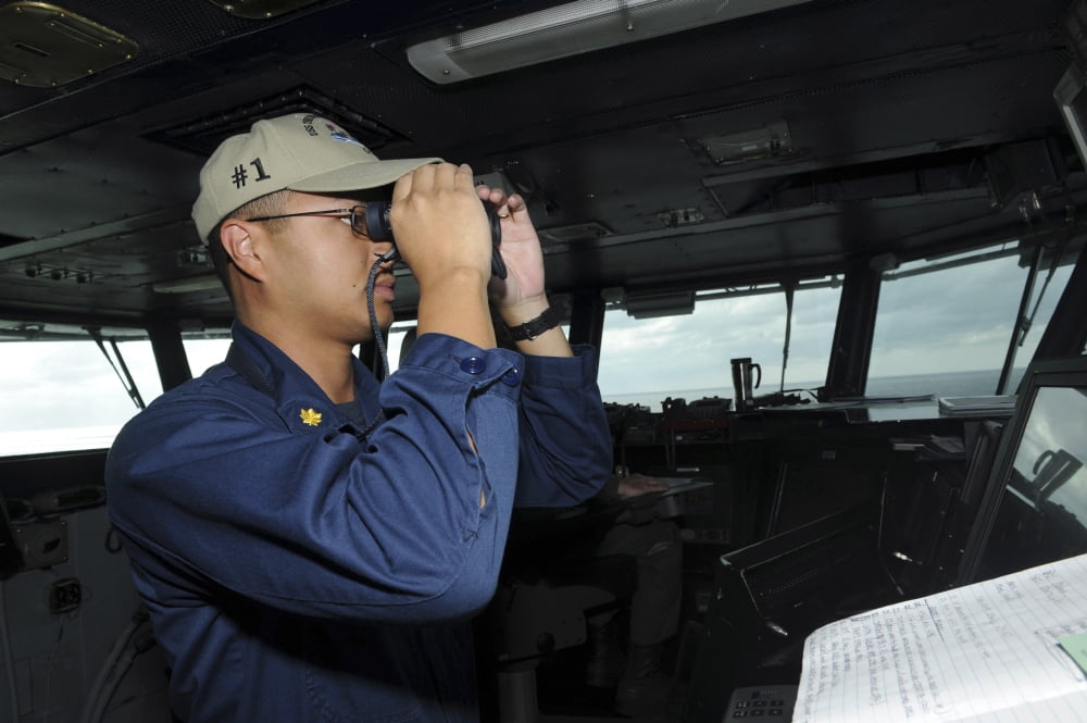 Lieutenant looks for contacts from the pilot house aboard USS Theodore Roosevelt Canvas Art - Stocktrek Images (34 x 23)