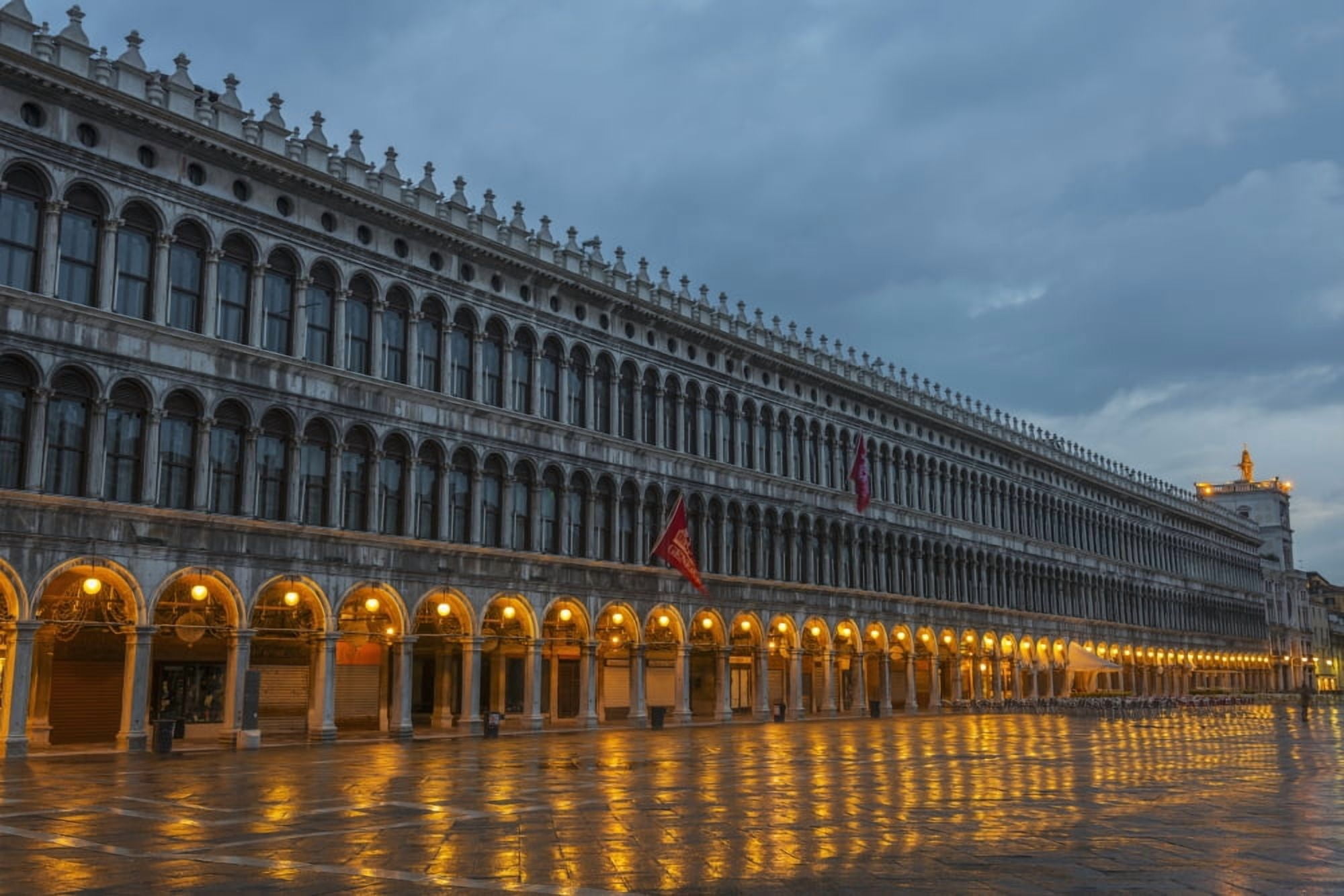 Lighted archways in a row along a building reflected in the wet pavement Piazza san marco Venice Veneto Italy Canvas Art - Mats Silvan Design Pics (38 x 24)