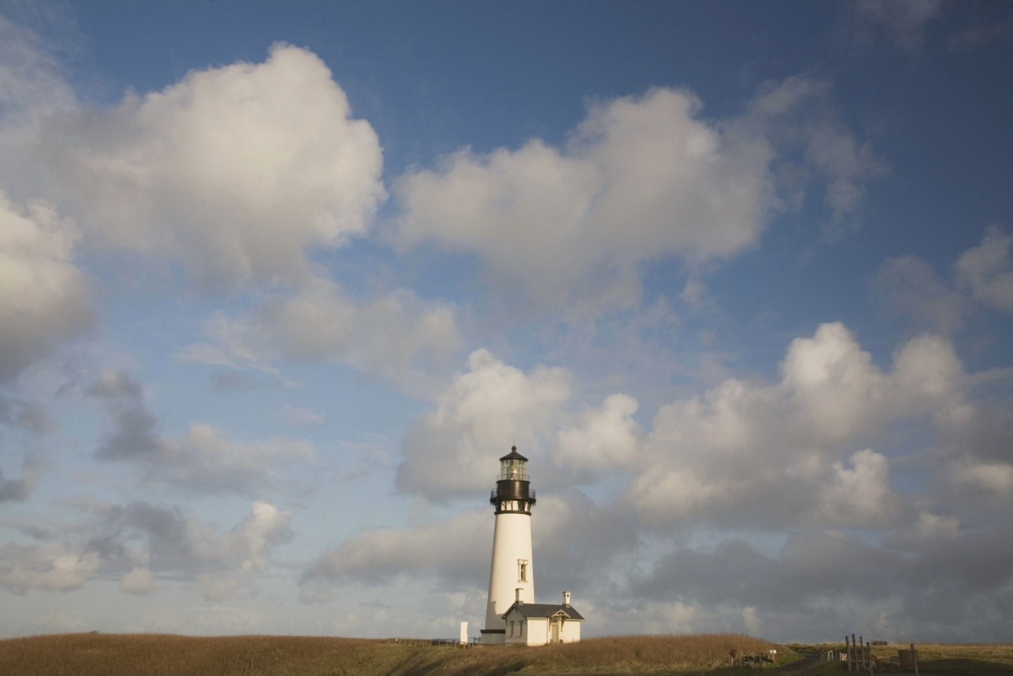 Lighthouse With Cloudy Backdrop Canvas Art - Craig Tuttle Design Pics (38 x 24)