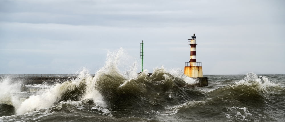 Lighthouse and splashing waves Amble Northumberland England Canvas Art - John Short Design Pics (23 x 10)