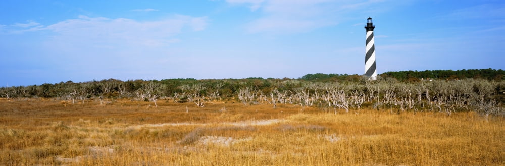 Lighthouse on the coast Cape Hatteras Lighthouse Outer Banks North Carolina USA Canvas Art - Panoramic Images (27 x 9)
