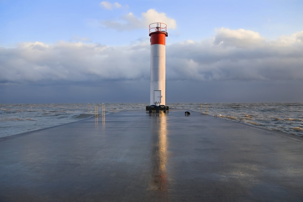 Lighthouse reflected on a wet pier on a stormy day by lake ontario whitby ontario canada Canvas Art - Mary Ellen McQuay Design Pics (38 x 24)