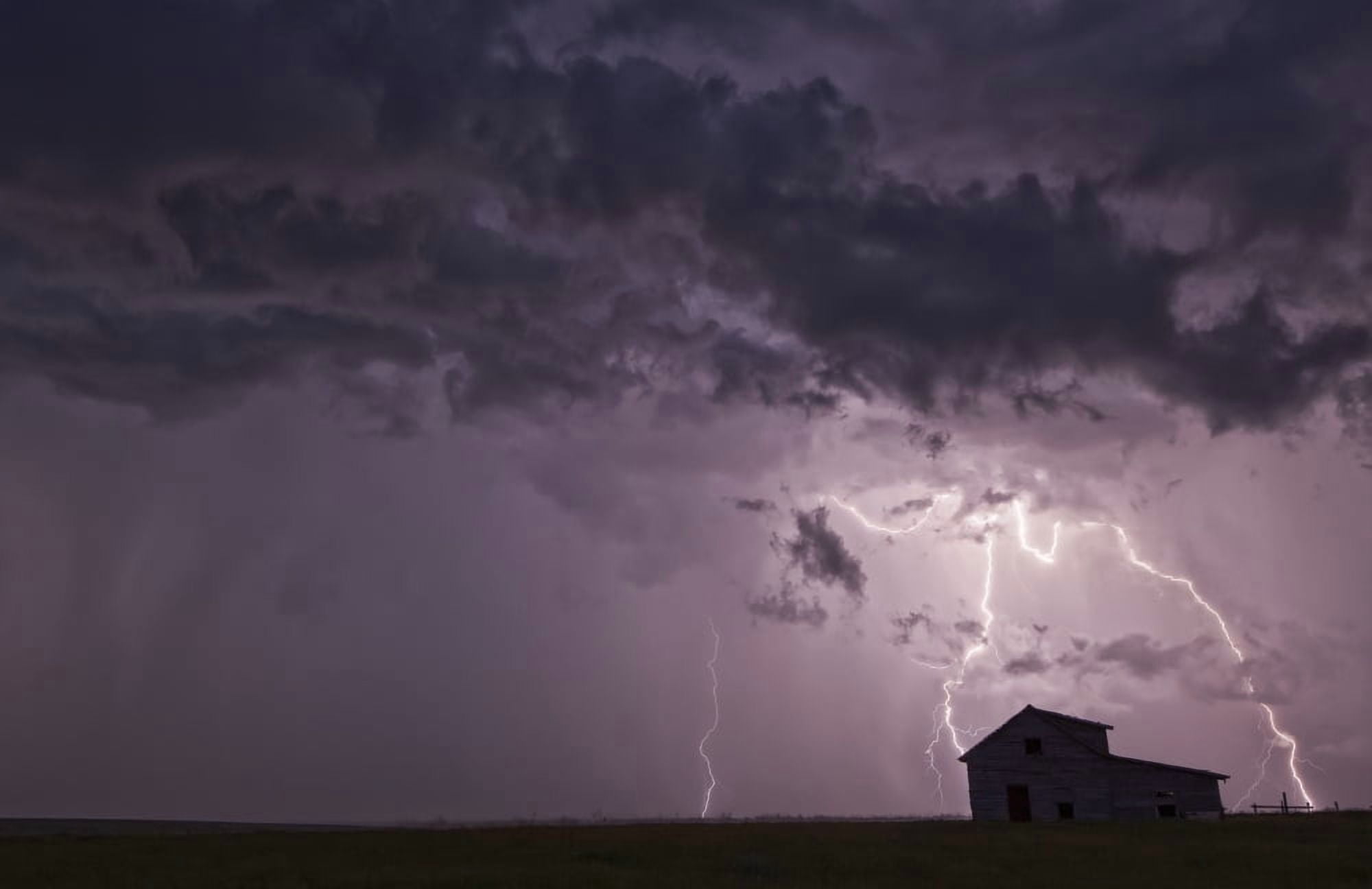Lightning strikes over the prairies as it approaches an old abandoned farm house Val Marie Saskatchewan Canada Canvas Art - Robert Postma Design Pics (34 x 22)