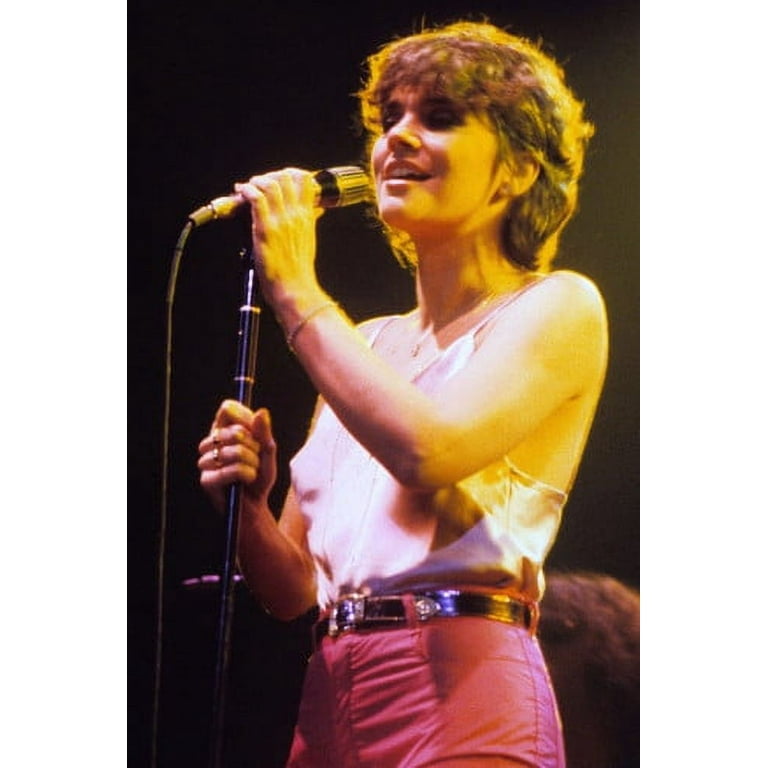 Linda Ronstadt in skimpy top performing in concert short