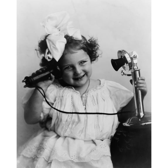 Little Girl Talking On An Early Model Telephone. Ca. 1905. History (18 x 24)