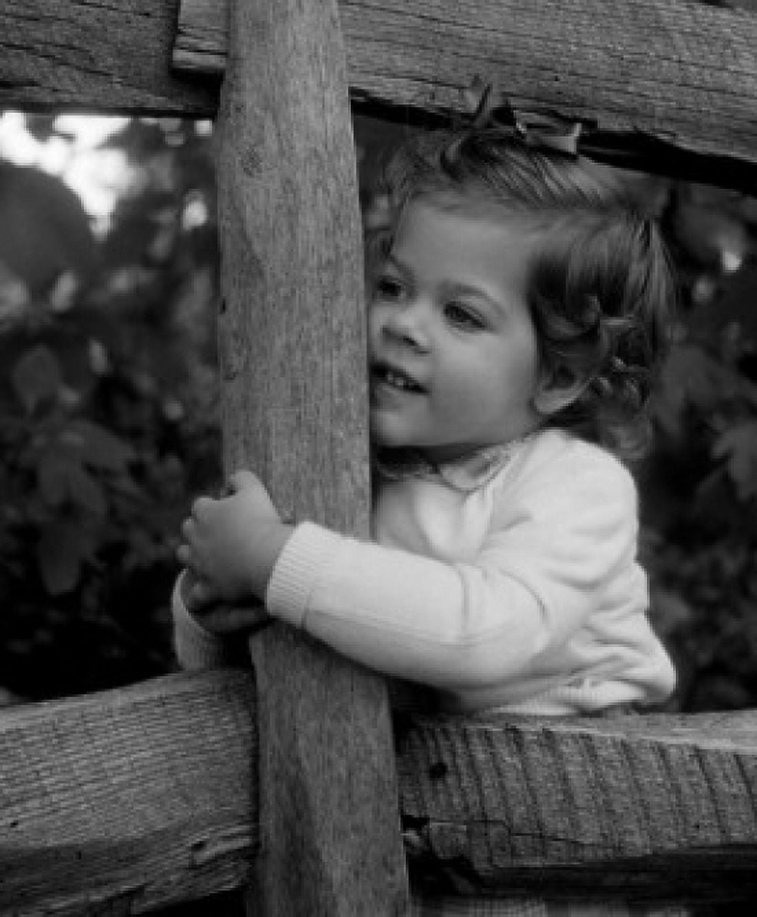 Little girl embracing fence Canvas Art - (18 x 24)