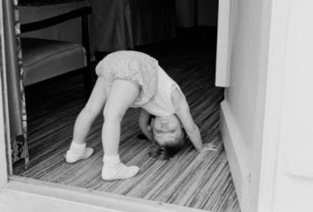 Little girl exercising in doorway Canvas Art - (24 x 36)