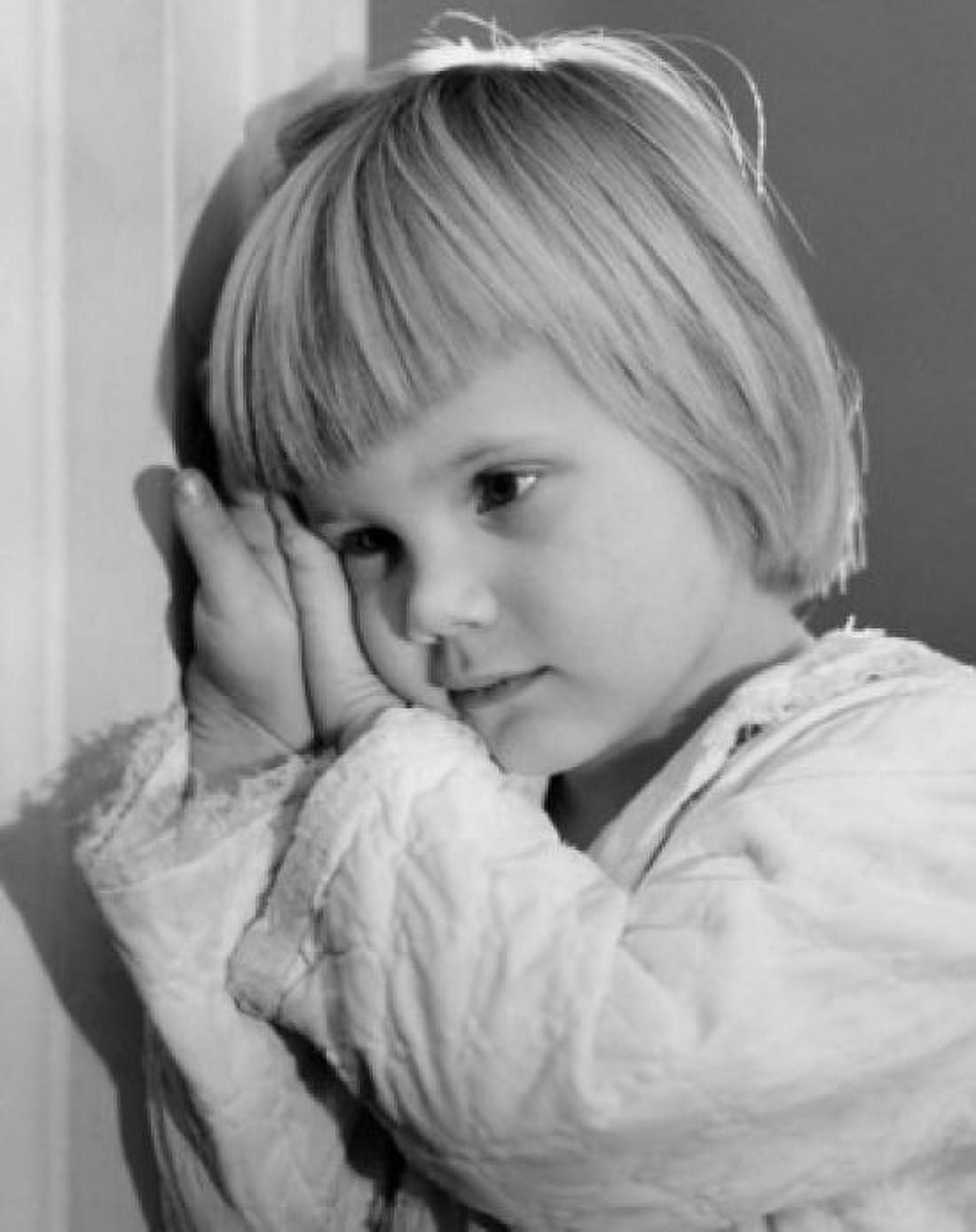 Little girl leaning against wall with hands clasped Canvas Art - (18 x 24)