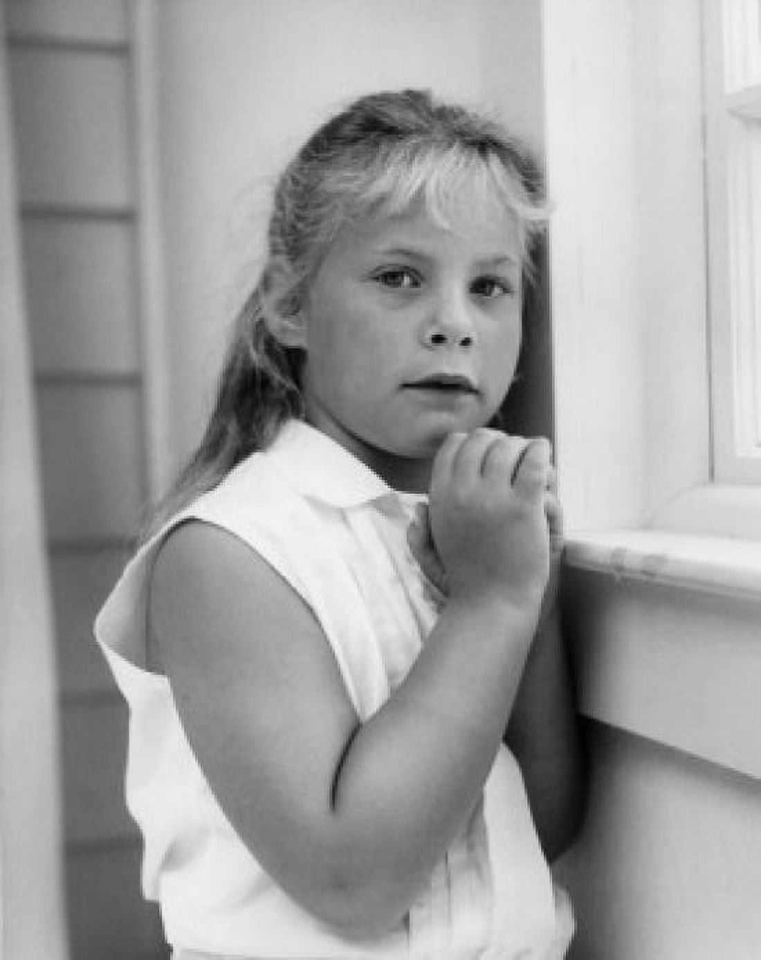 Little girl standing near window with hands folded Canvas Art - (18 x 24)