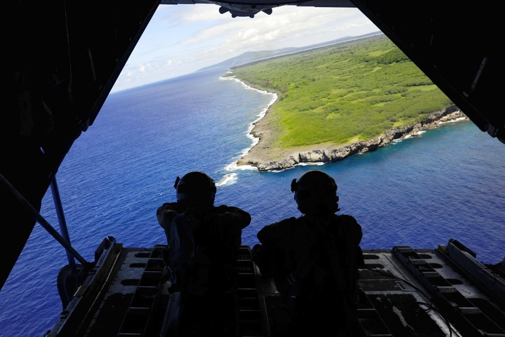 Loadmasters look out over Tumon Bay from a C-130 Hercules Canvas Art - Stocktrek Images (34 x 23)